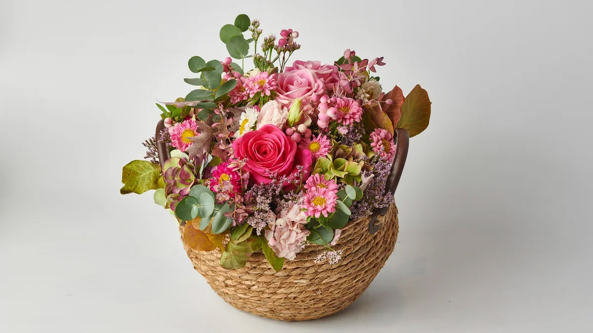 Composition with Fresh Seasonal Flowers in a Wicker Basket FLOWER ARRANGEMENTS Antheon
